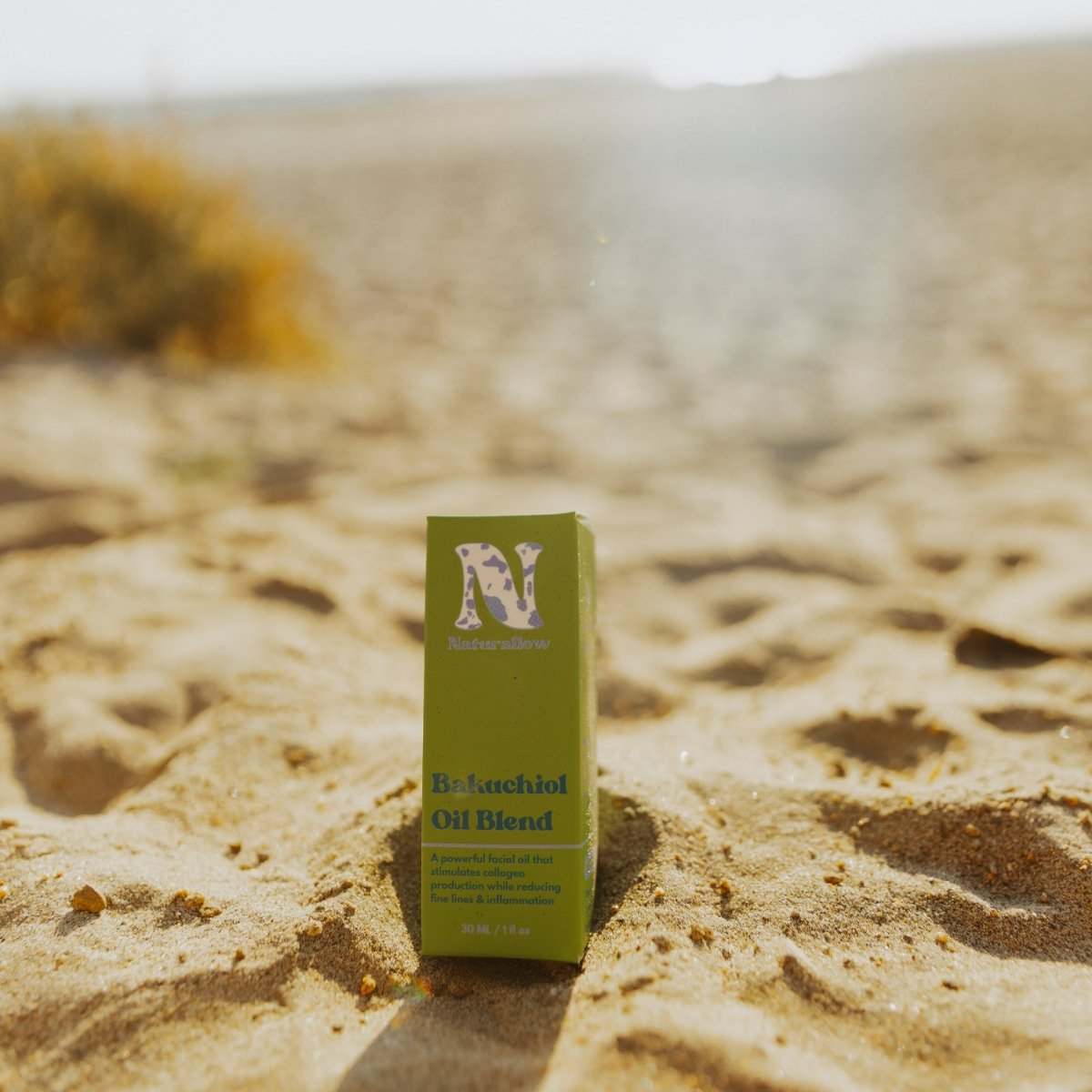 Naturallow Bakuchiol Facial Oil, box standing in the sand