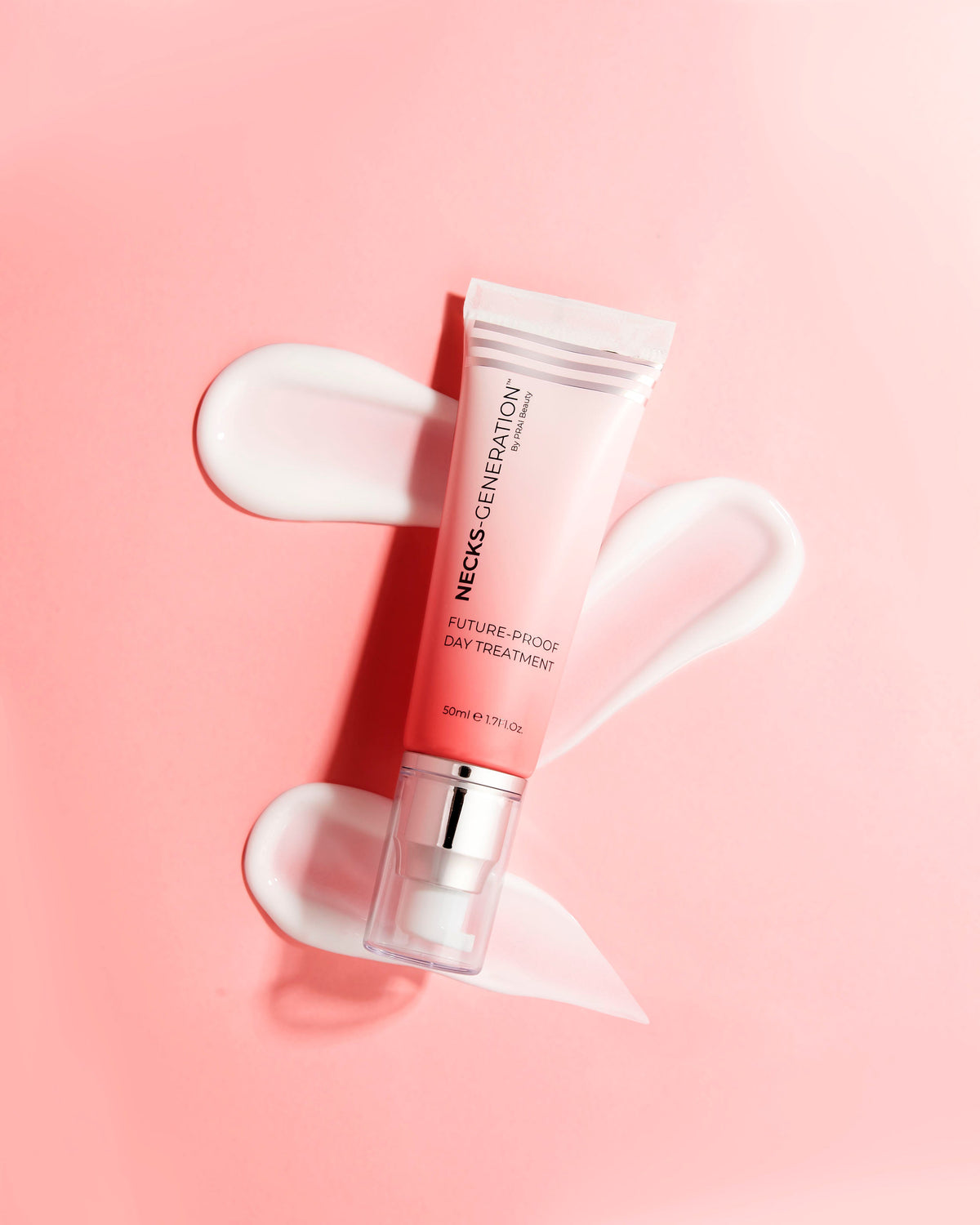 PRAI Beauty Necks-Generation Future-Proof Day Treatment, tube beside a swirl of creme on a pink background
