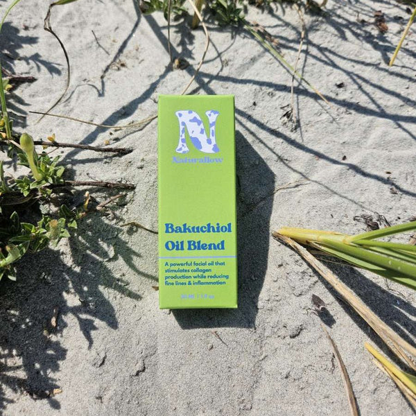 Naturallow Bakuchiol Facial Oil, box lying on sand with beach grass