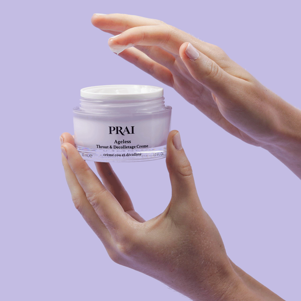 PRAI Beauty Ageless Throat & Decolletage Creme, hands holding an open jar